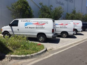 Three Coolco vans parked outside in a row