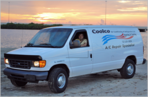Coolco van parked on the beach bright pink sunset driver smiling